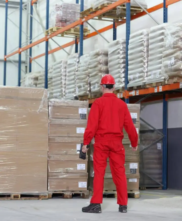 Worker in red standing in warehouse